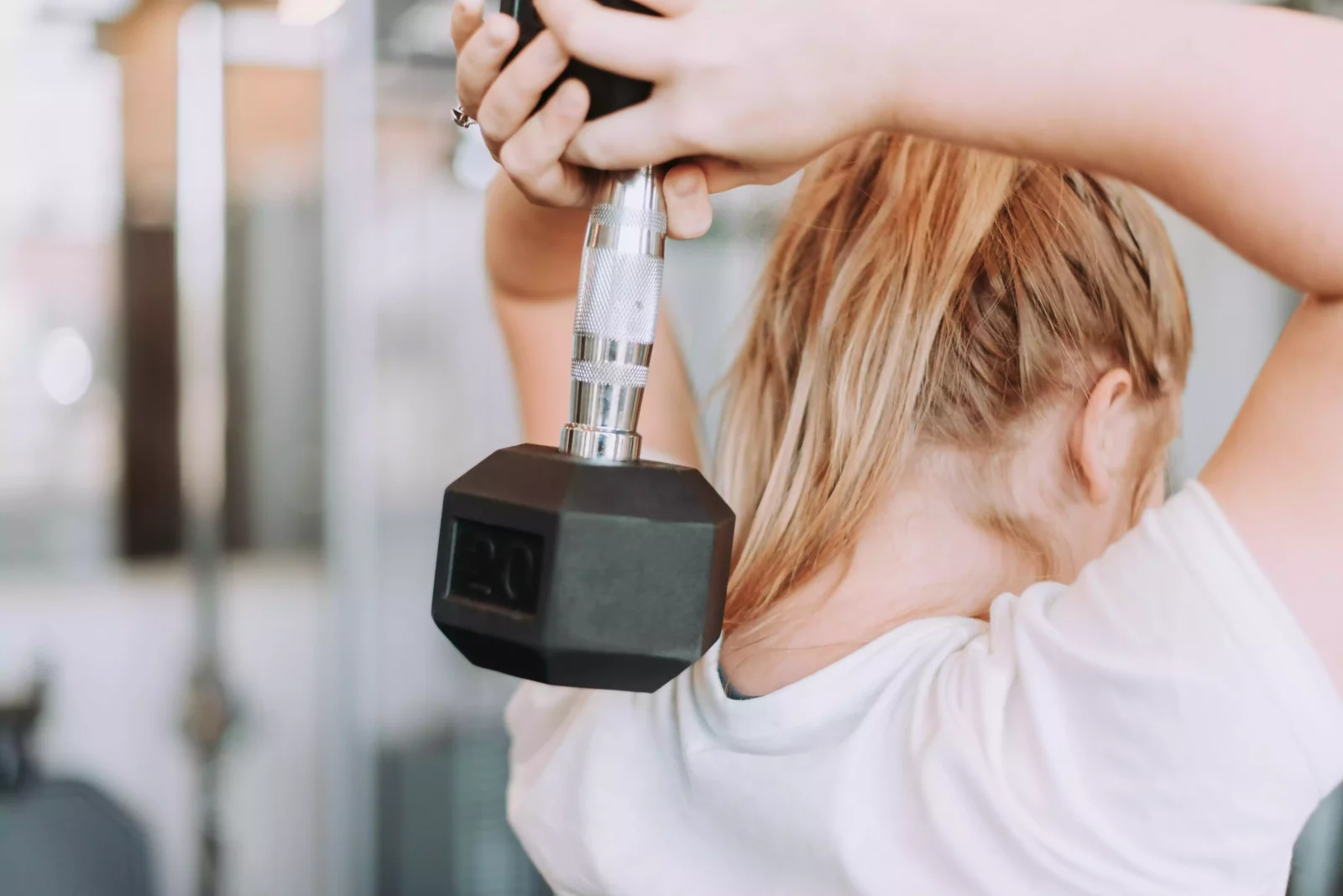 Woman exercising with dumble