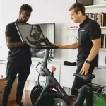 Two men with a Peloton Bike