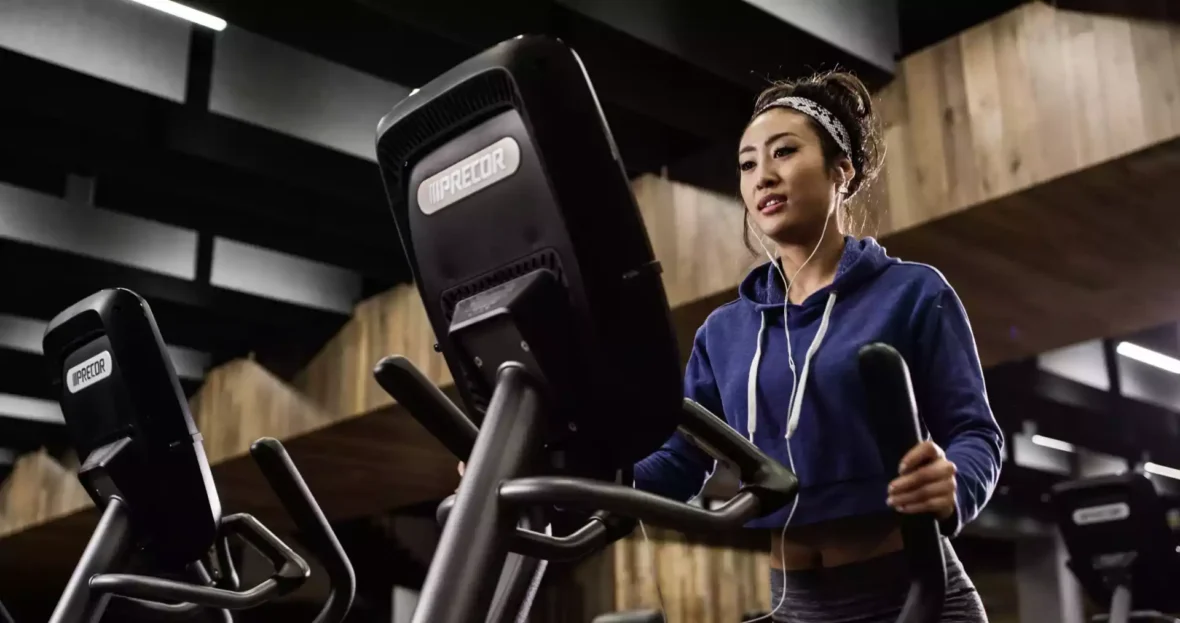 Woman using Precor equipment