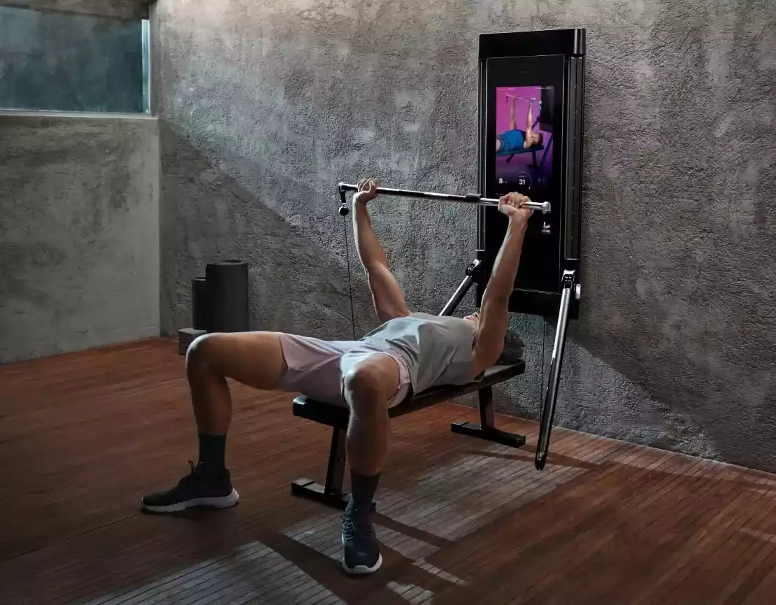 Man using Tonal smart home gym