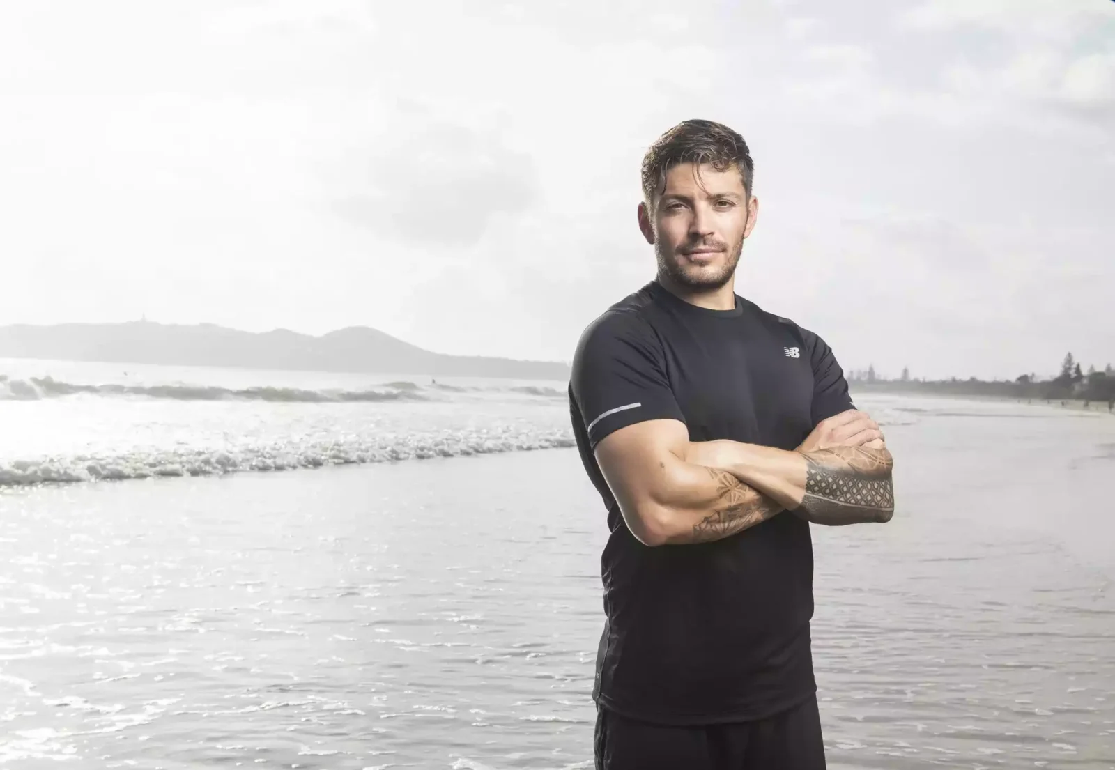 Luke Zocchi standing with hands folded near sea