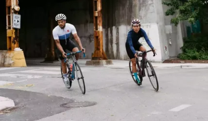 Two cyclists bicycling