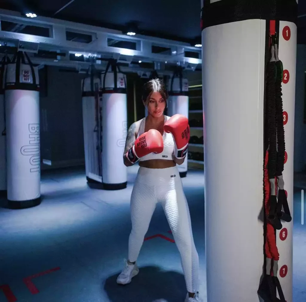 Woman punching Bhout, a boxing bag with a brain.