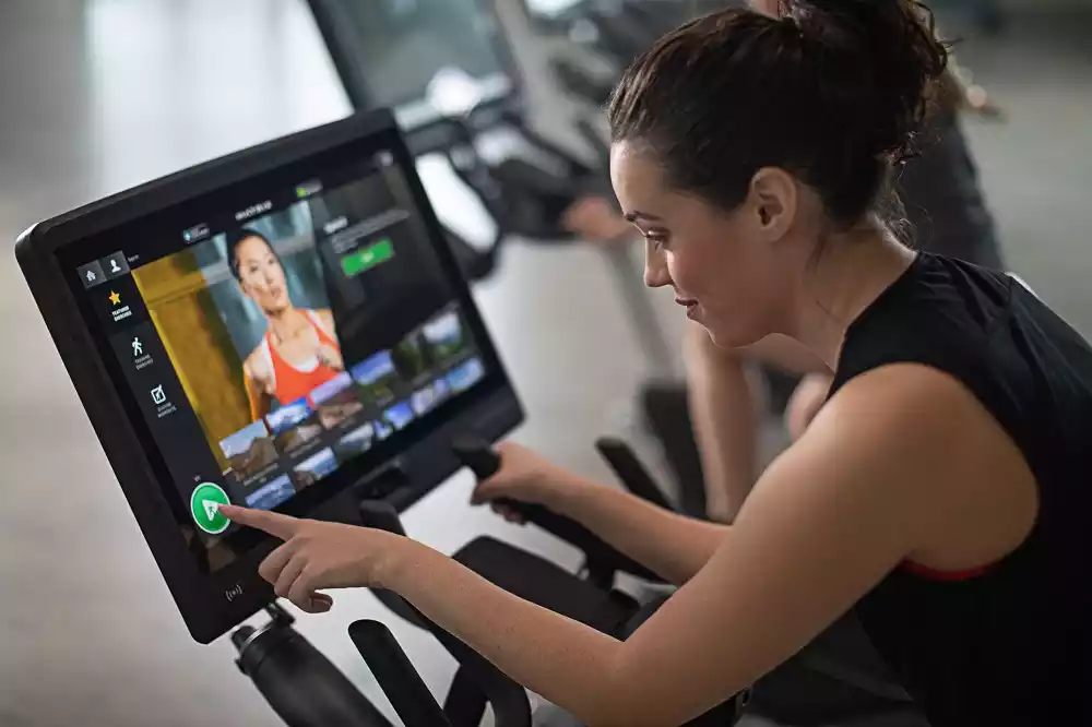 Woman using connected fitness equipment
