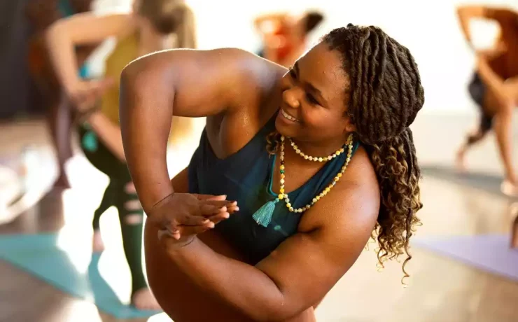A black woman doing yoga at a CorePower Yoga session