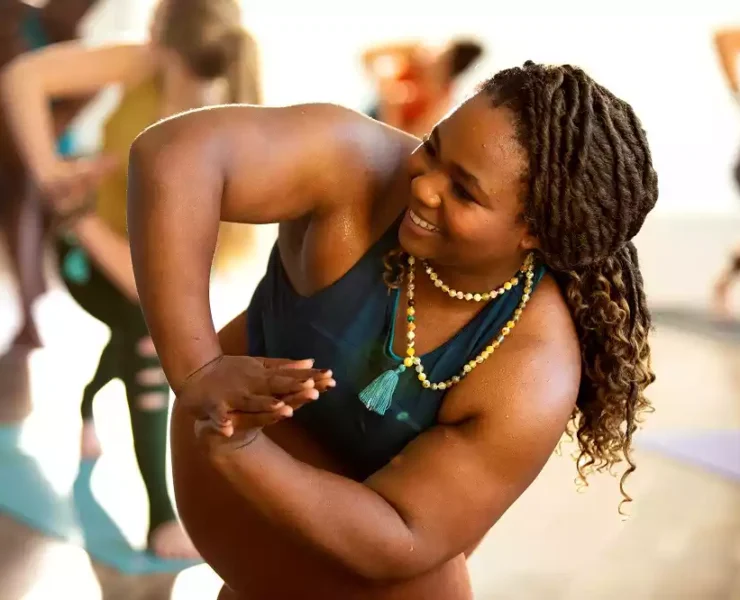 A black woman doing yoga at a CorePower Yoga session