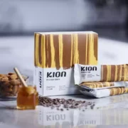 The Kion Chocolate Crunch Protein Bar and its ingredients on a surface