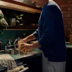 A man working in kitchen with Oura ring on his finger