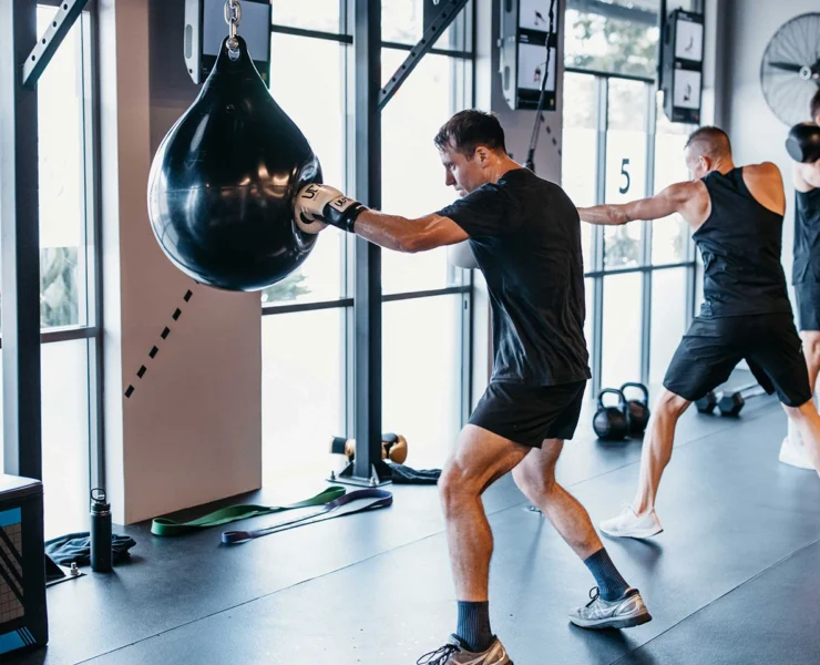 UBX boxing interior, member swinging at bags