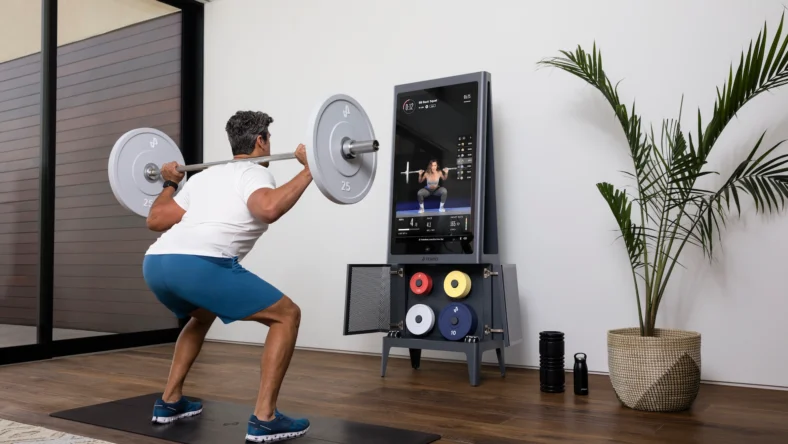man performs a back squat using Tempo strength training equipment