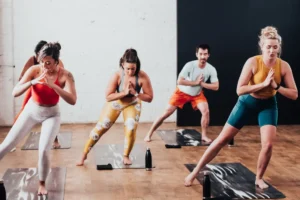 men and women in a yoga class