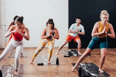 men and women in a yoga class