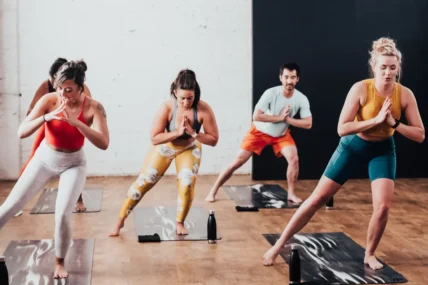 men and women in a yoga class