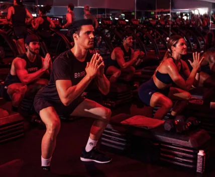 people workout inside a Barry's location