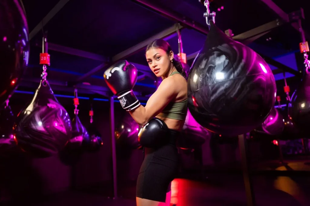 woman poses in a Rumble Boxing studio