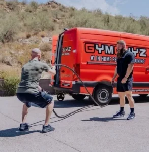 man workouts at outside a GymGuyz van