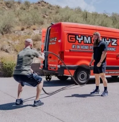 man workouts at outside a GymGuyz van