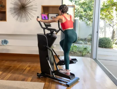 woman works out on a BowFlex elliptical