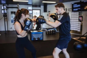 man and woman spar at a UBX studio
