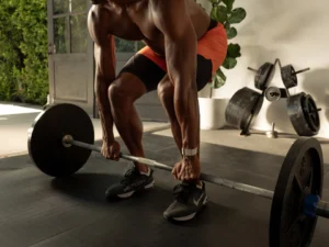 man lifts a barbell with a Whoop on his wrist