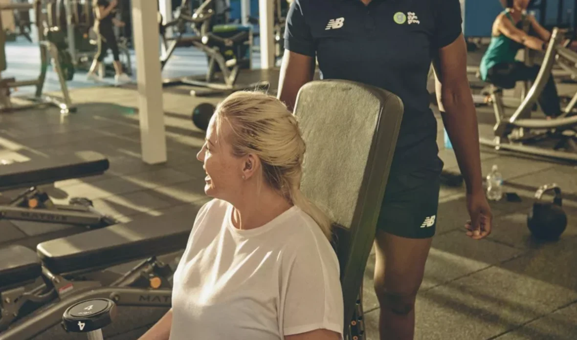 woman sitting on gym bench