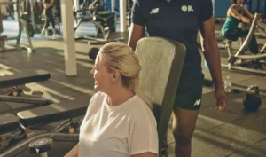 woman sitting on gym bench