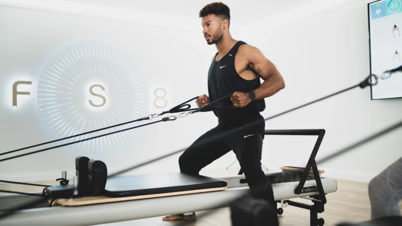 Man does Pilates exercise at FS8 studio