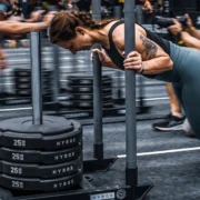 Woman pushing sled of weights