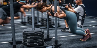 Woman pushing sled of weights