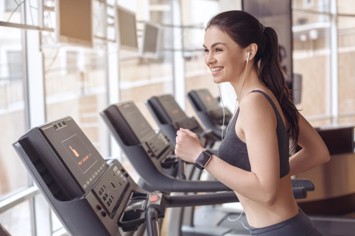 woman runs on treadmill at gym