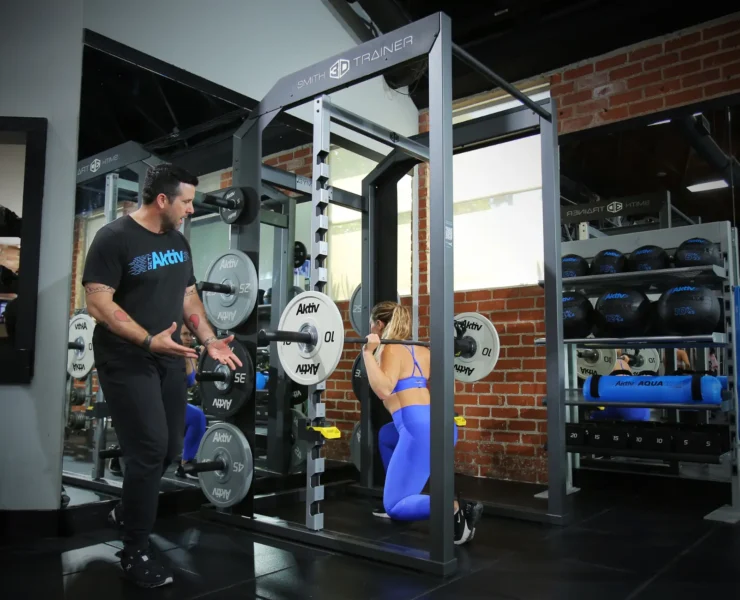 woman works out in a smith machine from Akitv Solutions