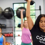 An Anytime Fitness coach leading a small group strength class.