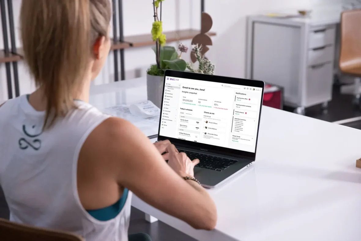 Fitness studio owner looking at her sales dashboard