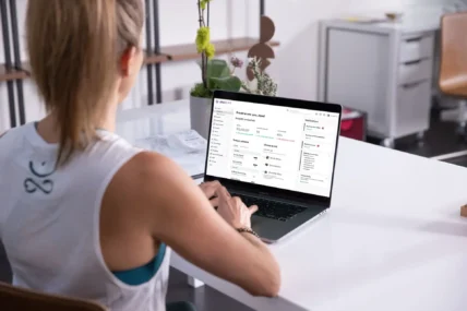 Fitness studio owner looking at her sales dashboard