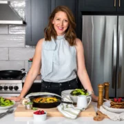 a smiling image of Dr. Casey Means in a kitchen