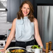 a smiling image of Dr. Casey Means in a kitchen