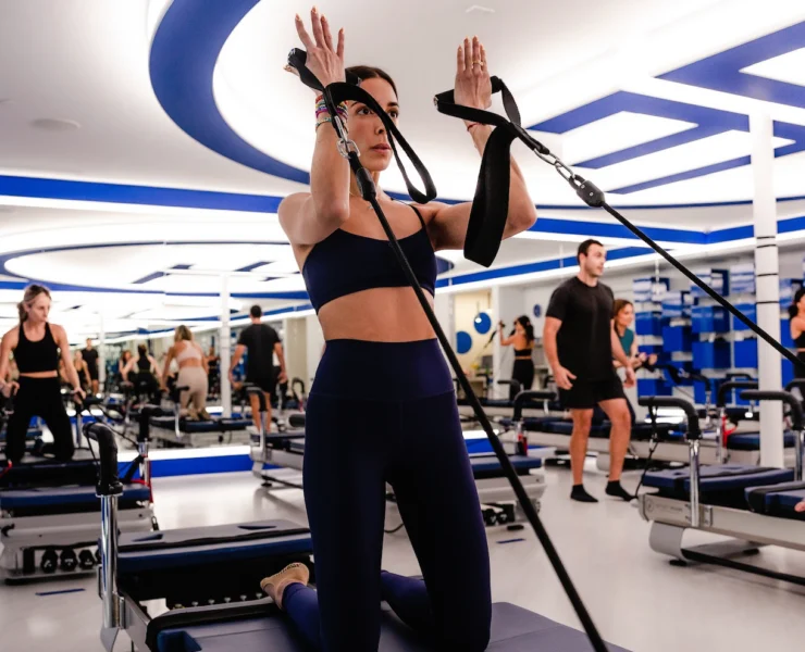an image of a woman working out on a JetSet Pilates reformer