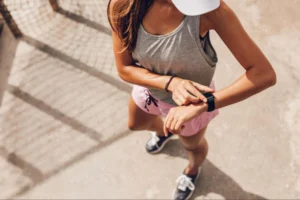 woman checks her smartwatch