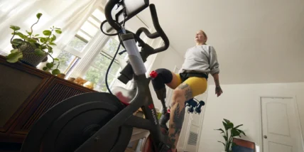 woman works out on a Peloton bike