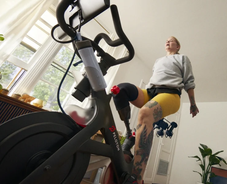 woman works out on a Peloton bike