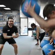 Personal trainer teaching a class with medicine balls