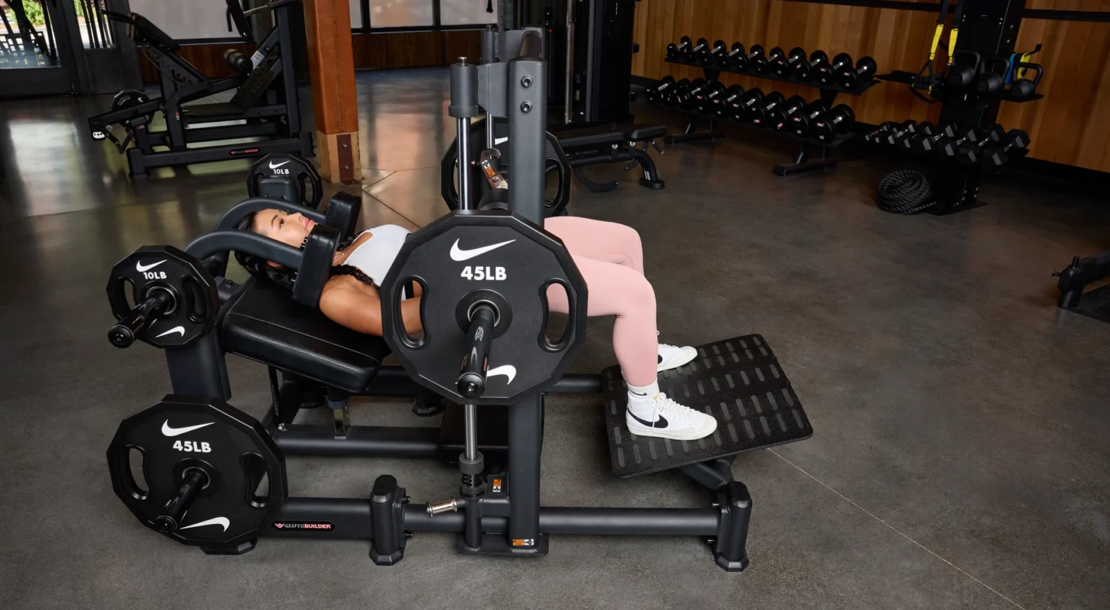 A woman using the Precor Glutebuilder machine