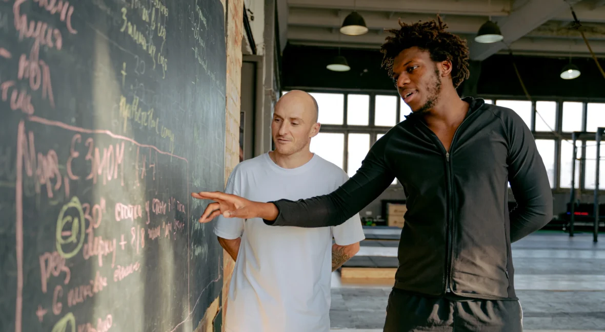 Personal trainer showing client the workout of the day