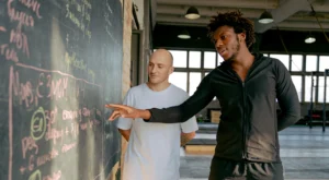 Personal trainer showing client the workout of the day