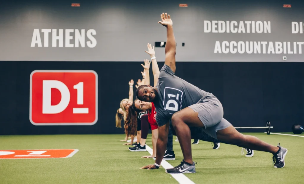 men and women work out at a D1 Training location