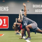 men and women work out at a D1 Training location