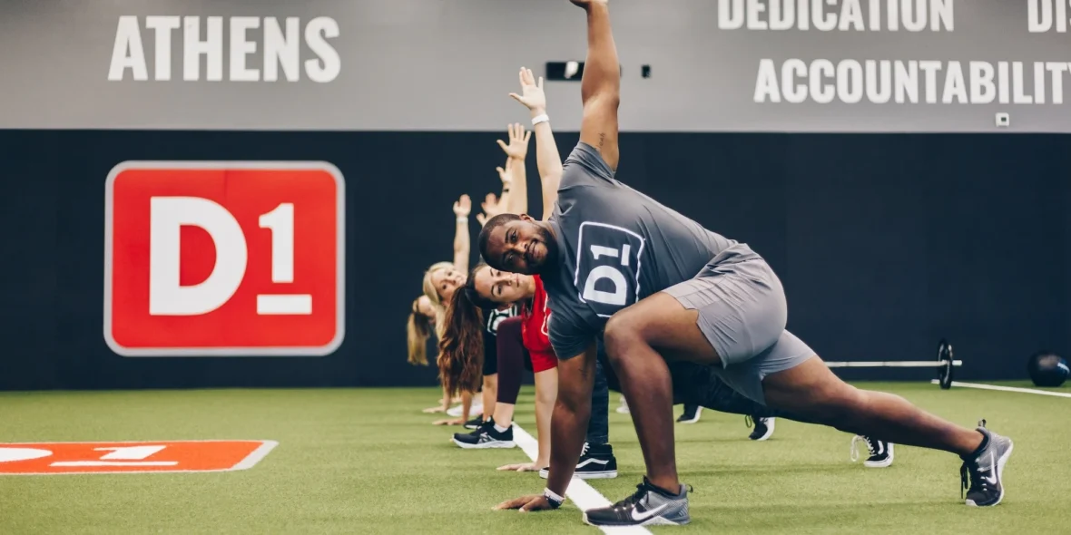 men and women work out at a D1 Training location