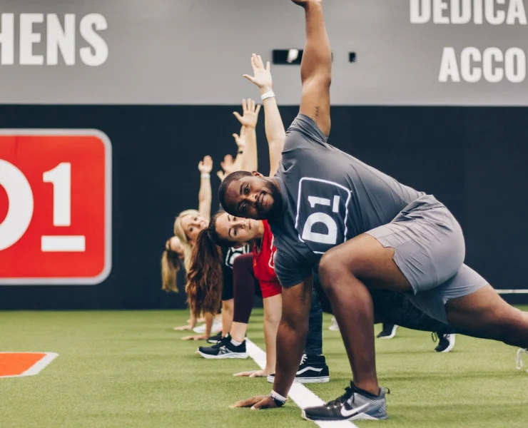 men and women work out at a D1 Training location