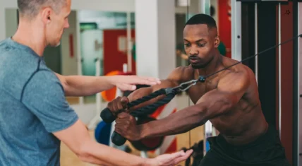 Personal trainer working out with client