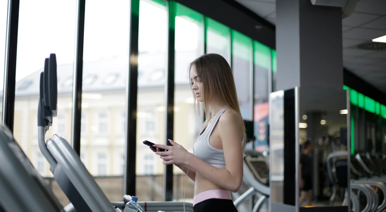 Young woman on treadmill at gym